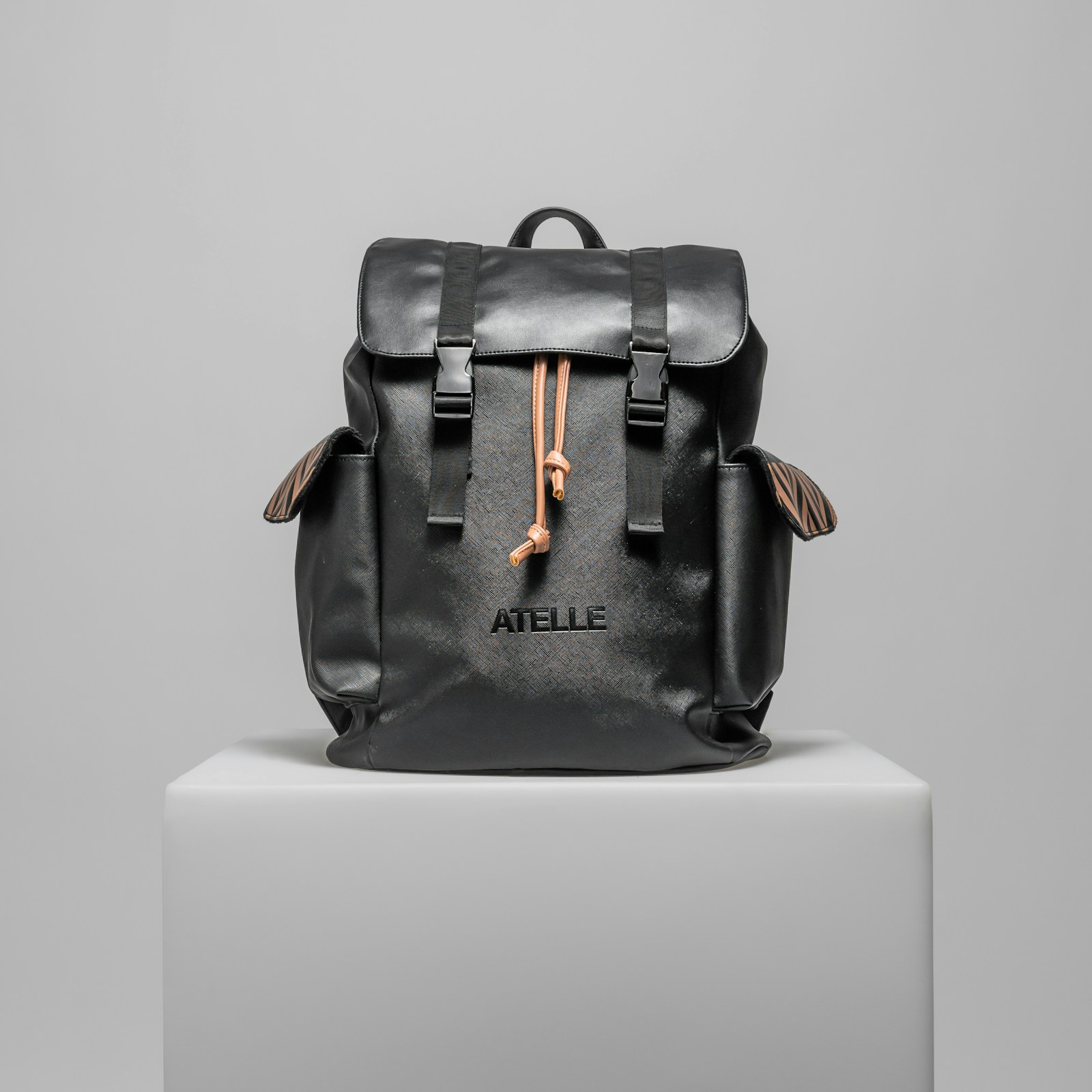 Black everyday carry backpack on a white pedestal